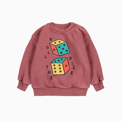 Rusty colored baby sweatshirt with two colorful dice graphic and text reading Roll The Dice on a white background