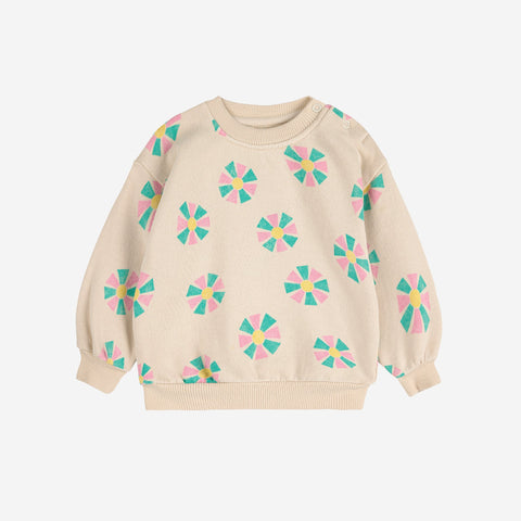 Beige baby sweater with colorful kaleidoscope patterns on a white background