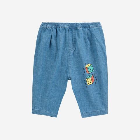 Blue denim baby pants with colorful dice design on a white background