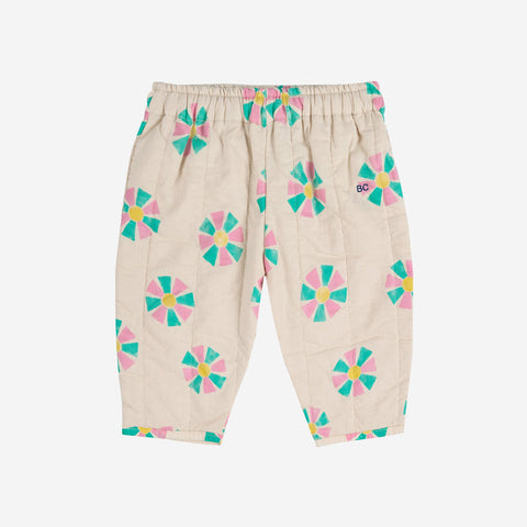 Quilted beige baby pants with colorful kaleidoscope patterns on a white background
