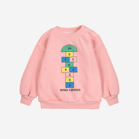 Pink baby sweatshirt with colorful hopscotch number design and Bobo Choses text on a white background